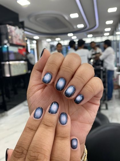 A beautiful example of a circular cat-eye effect, creating a mesmerizing, galaxy-like look on the nails.