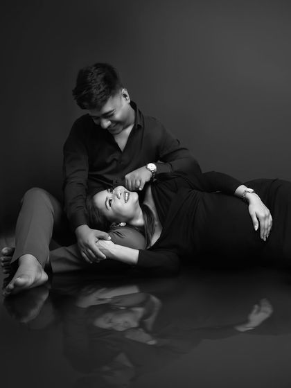 The same intimate pose in black and white. The monochrome edit enhances the emotional depth and timelessness of the moment, focusing purely on their connection.