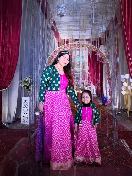This is one of my favorite projects, where I upcycled an old silk saree to create these matching pink and green dresses for my daughter and me. It shows that old clothes can be transformed into something new and full of memories.