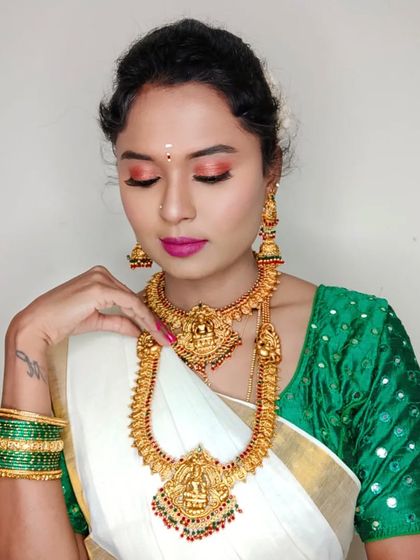 This is a festival look I created for myself for Onam. I paired my traditional white and green saree with bright pink nails for a modern twist.