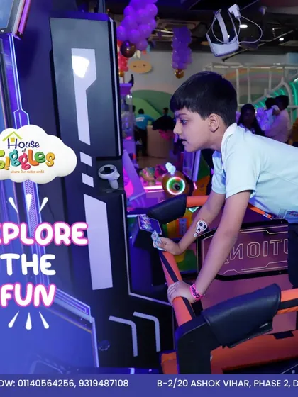 Explore the fun in our glowing arcade zone. This young player is completely focused on his game, surrounded by the neon lights and exciting atmosphere of our gaming area.