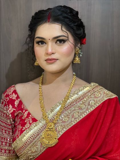 A close-up of the traditional Bengali makeup, featuring bold, expressive eyes and a perfectly placed bindi.