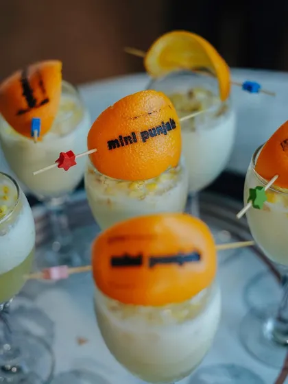 Our custom-branded mocktails, featuring an orange peel with the Mini Punjab logo. This is another example of our personalized service.