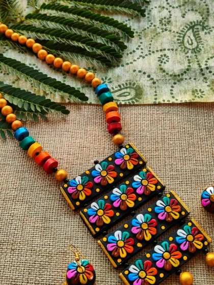 Another angle of the multi-layered floral necklace, showing how the colorful beads on the chain complement the flowers on the pendant. It's a truly joyful and vibrant piece.