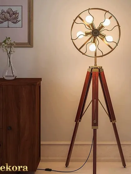 Make a bold statement with this unique fan-shaped tripod lamp. Featuring five exposed bulbs in a circular brass frame, this piece is functional art, ideal for industrial or eclectic interiors that need a conversation starter.