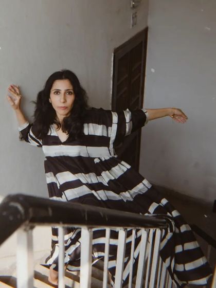 A portrait from a shoot with House of Wandering Silk, capturing a moment of movement and grace on a staircase.