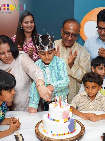 A beautiful family moment as Ali cuts his art-themed birthday cake, surrounded by his loved ones.