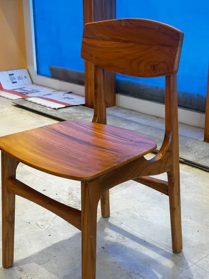 This simple yet elegant dining chair was part of a custom furniture set I created for a cafe in JP Nagar. Made entirely of solid teak wood, its clean lines and ergonomic design are perfect for high-traffic commercial use.