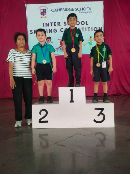 Three of our young champions on the podium, celebrating their wins in the inter-school skating event. Their dedication and practice paid off.