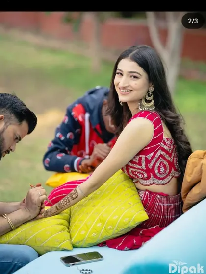 A candid shot of me applying mehndi for a smiling bride during her ceremony.