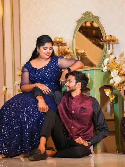 An intimate moment in a lavishly decorated room. The couple's elegant outfits are perfect for this royal-themed indoor set.
