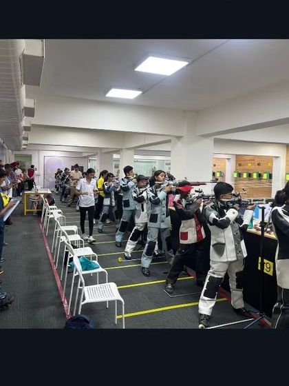 The range is filled with young competitors, each focused on their performance, demonstrating the high-stakes environment of a national-level tournament.