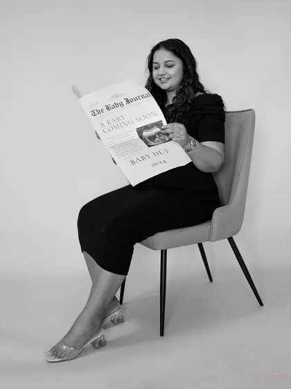 A fun and creative announcement shot, rendered in beautiful black and white. It gives a classic, old-timey newspaper feel to her special edition 'Baby Journal'.