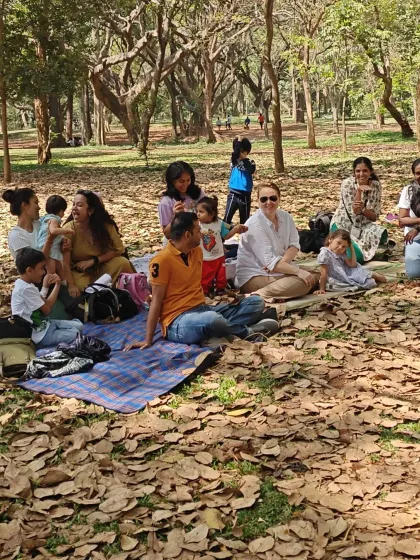 Our kind of Sunday. A group of families relaxing on picnic blankets, surrounded by fallen leaves and the gentle sounds of the forest.