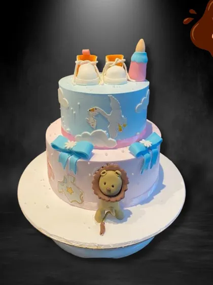 This adorable two-tier baby shower cake features a stork delivering a baby, tiny fondant shoes, and a cute lion. The soft pink and blue colors make it a sweet and gentle theme for welcoming a little one.