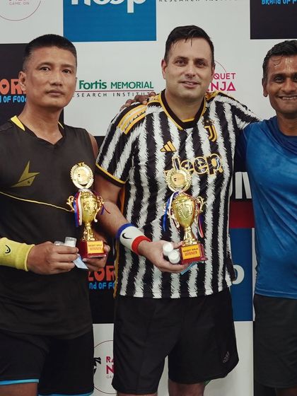 Winners from different age and skill categories posing with their trophies. My events are structured to be inclusive, with categories for 30+, 35+, and 40+ to ensure fair and exciting matches for all.