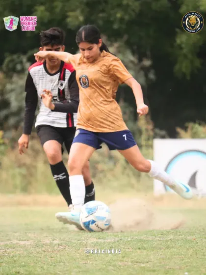 An action shot capturing the raw power of our player striking the ball, kicking up a cloud of dust. This image shows the fierce determination we bring to every single match.