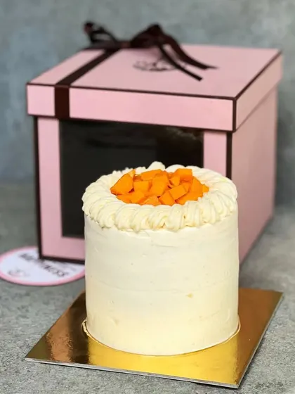 A mini version of my mango buttercream cake, perfectly sized for gifting and presented in a classic pink box.