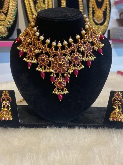 A stunning floral design choker set made entirely with deep ruby-colored stones, perfect for pairing with red or gold outfits.