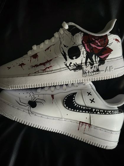 A top-down view of the skull and spider Halloween custom sneakers.