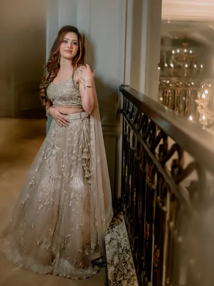 A full-length shot of Simran, capturing the elegance of her gown and her graceful pose against a luxurious backdrop.