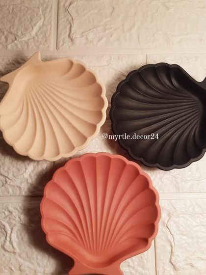 A collection of our mini shell dishes in three popular solid colors: a soft beige, a bold black, and a warm terracotta.