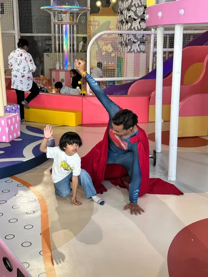 Another shot of our Superman mascot posing with the birthday boy, creating a treasured memory.