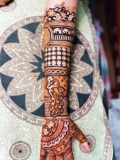 A single-arm view of a complex design featuring bands of elephants, peacocks, and jaali work. This showcases the variety of motifs I can incorporate into one cohesive piece.
