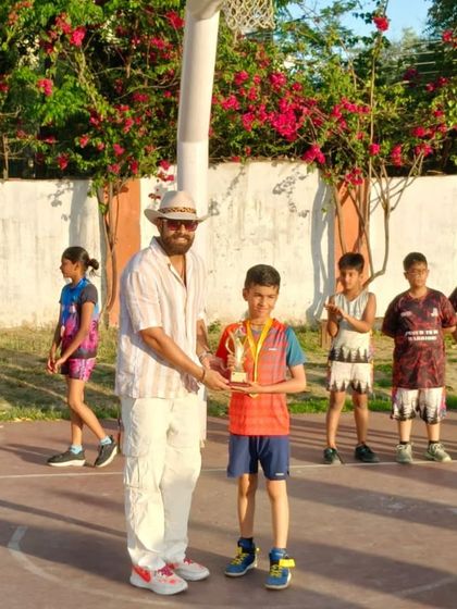 Presenting a trophy to a standout player for his excellent performance in the tournament.