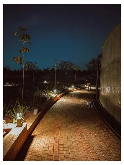 The landscaped pathway at night, with low-level lighting creating a safe and inviting walkway around the complex.