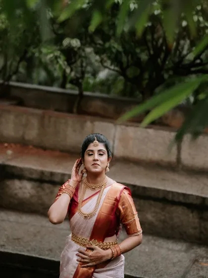 A moment of quiet reflection for the bride. This close-up captures her adjusting her hair, a simple gesture filled with grace.