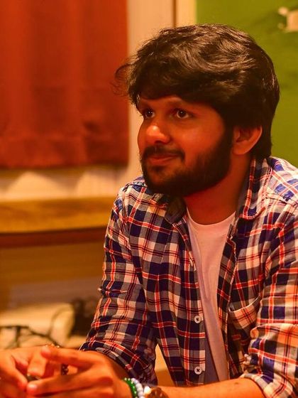 A portrait of a performer, captured in a moment of reflection during the "Rhyme and Rhythm" collective event.