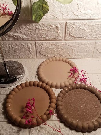 Our brown-toned bubble trays styled with a mirror, showing how they fit into a neutral, aesthetic space.