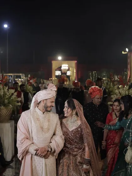 Capturing the quiet moments amidst the grand celebration is key. Here, the couple shares a look of love and happiness as they walk through their beautifully decorated wedding venue.