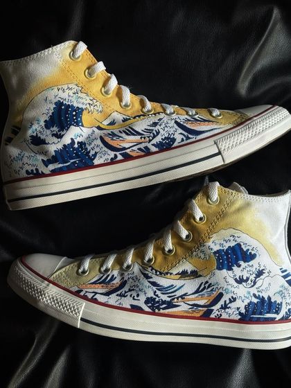 A pair of Converse high-tops featuring the iconic "The Great Wave off Kanagawa" painting.