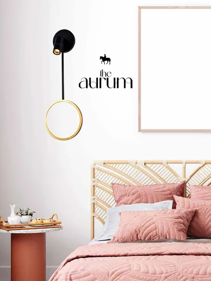 A modern, adjustable wall light provides focused reading light over the bed. Its sleek black and gold design is a perfect example of how I blend sophistication with innovation for timeless elegance.