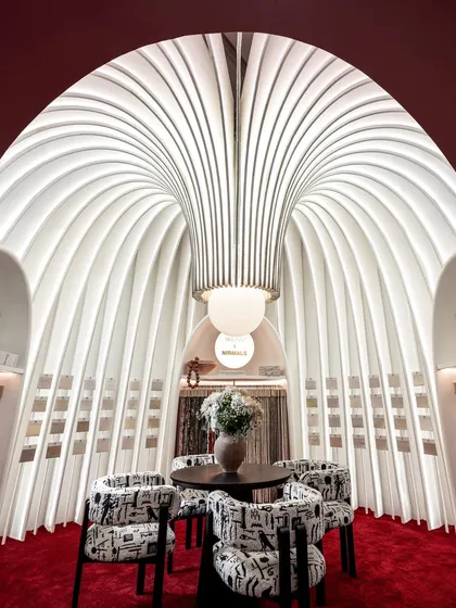 This was our ode to the silent power of fabric. For this award-winning exhibition booth, we sculpted a sanctuary from sheer white fins and soft light, creating a space that felt like walking through a poem. The structure itself became the art, inviting visitors into a serene, elegant world.