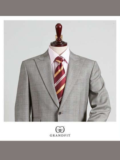 This two-piece grey suit is a versatile classic. Paired with a striped tie, it creates a look that is both professional and effortlessly stylish.