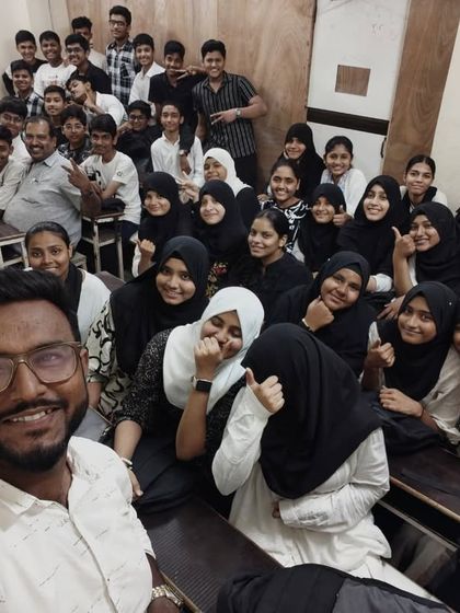 The whole class at the Mhada branch gives a thumbs-up, celebrating Black and White Day with their teacher.