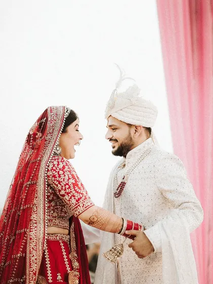 A moment of pure, unscripted laughter during the ceremony. This candid shot captures the genuine joy and connection between the couple, a beautiful memory from their special day.