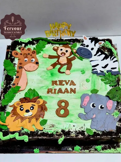 A fun jungle animal cake for an 8th birthday. This square cake is decorated with fondant animals like a lion, monkey, zebra, and elephant on a green background.