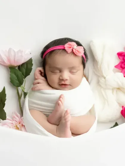 Another beautiful pose from our pink floral session, with the baby in a classic swaddled position.