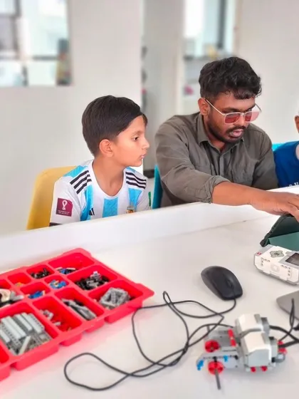 Our instructors are always there to help students take the next step. Here, an instructor guides two campers through a more advanced programming concept using LEGO Education kits.