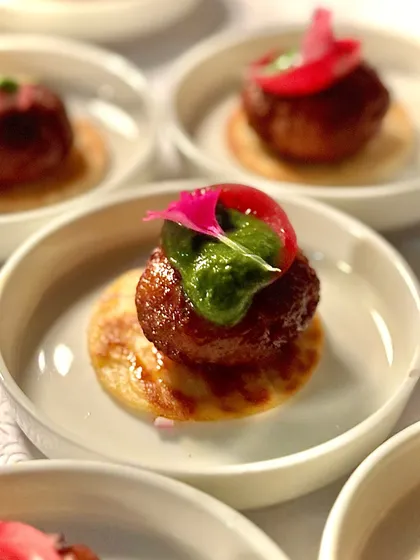 One of our most-loved dishes, the Lamb Galouti kebab. Melt-in-your-mouth tender lamb, infused with our secret spice blend, served on a mini saffron roti. It's a bite of modern Awadhi luxury that your guests will talk about long after the party ends.