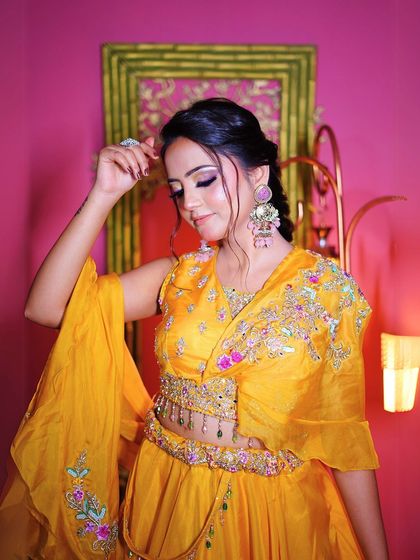 A close-up of the beautiful makeup and oversized earrings that perfectly complement the yellow outfit.