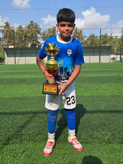 This young player from the U14 team proudly holds his trophy.