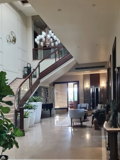 There is something special about a space that blends the old and the new. Here, a classic curved staircase and grand piano meet modern furnishings, creating a home that feels timeless yet fresh.