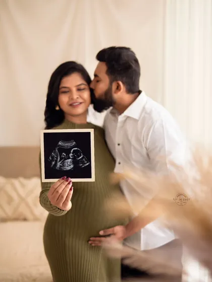 The first hello. This tender couple's portrait focuses on the pure joy and anticipation of parenthood, with the sonogram picture taking center stage as the first portrait of your little one.