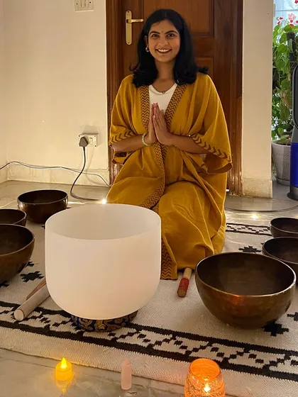 Our guide Riya, surrounded by her instruments of healing. Her sessions are a journey into sound, designed to bring peace and balance to your entire being.