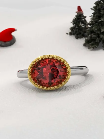 A fiery masterpiece to ignite your holiday elegance. This custom ring features a brilliant red gemstone in a textured gold bezel setting on a simple white gold band, a modern design with a classic feel.